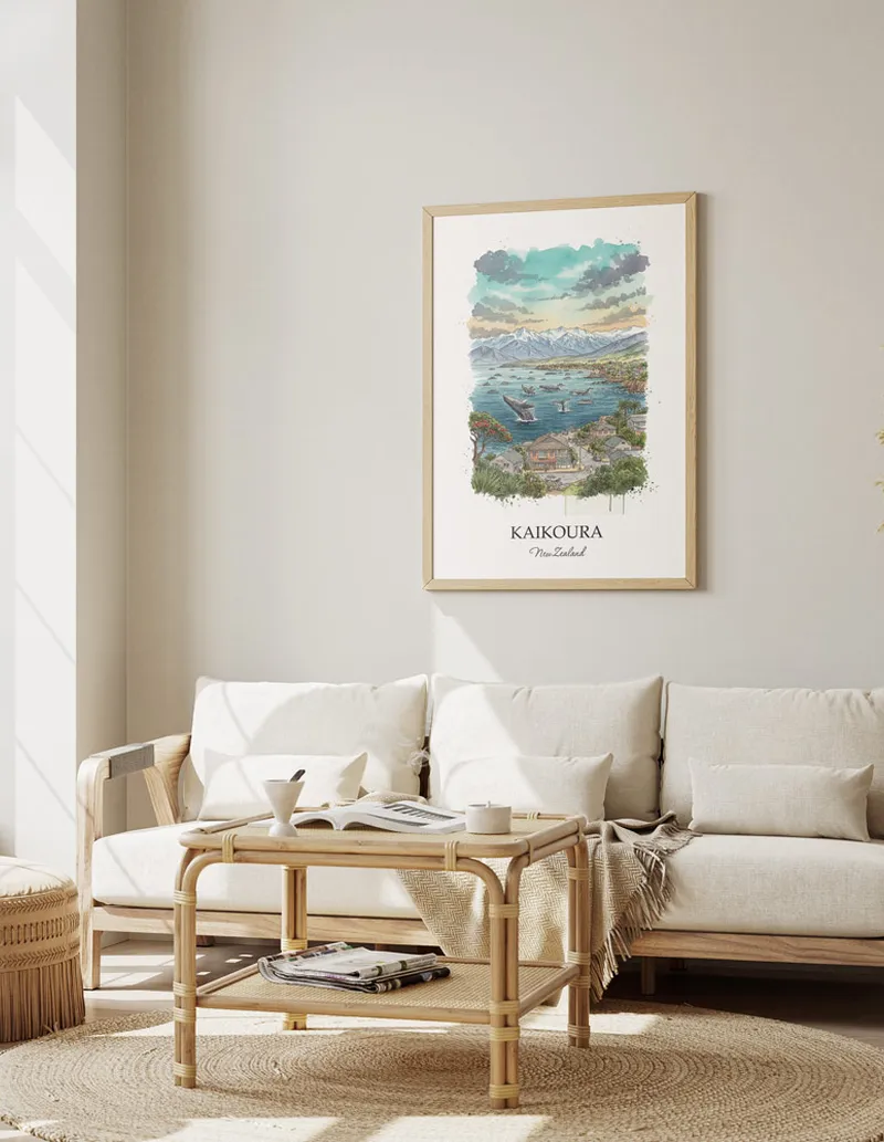 Framed wall art featuring Kaikoura in New Zealand in a light wood frame leaning on the floor.