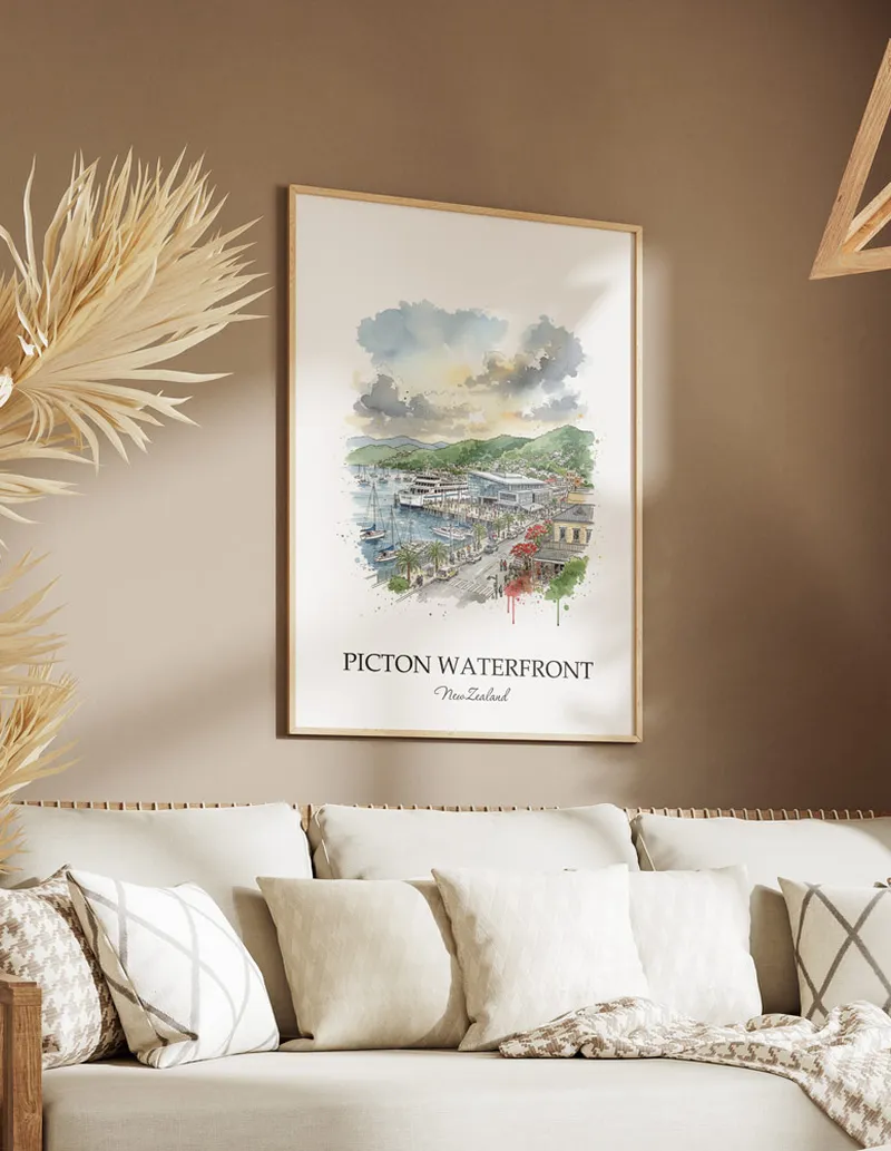 Minimalist poster of Picton Waterfront in New Zealand in a light frame standing on the floor in a dark moody interior.