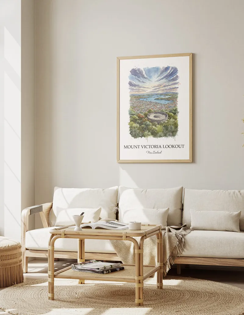 Framed wall art featuring Mount Victoria Lookout in New Zealand in a light wood frame leaning on the floor.