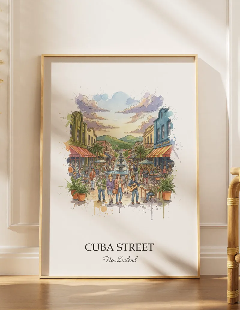 A gorgeous boho-inspired living space with a framed vintage travel poster of Cuba Street in New Zealand on display.