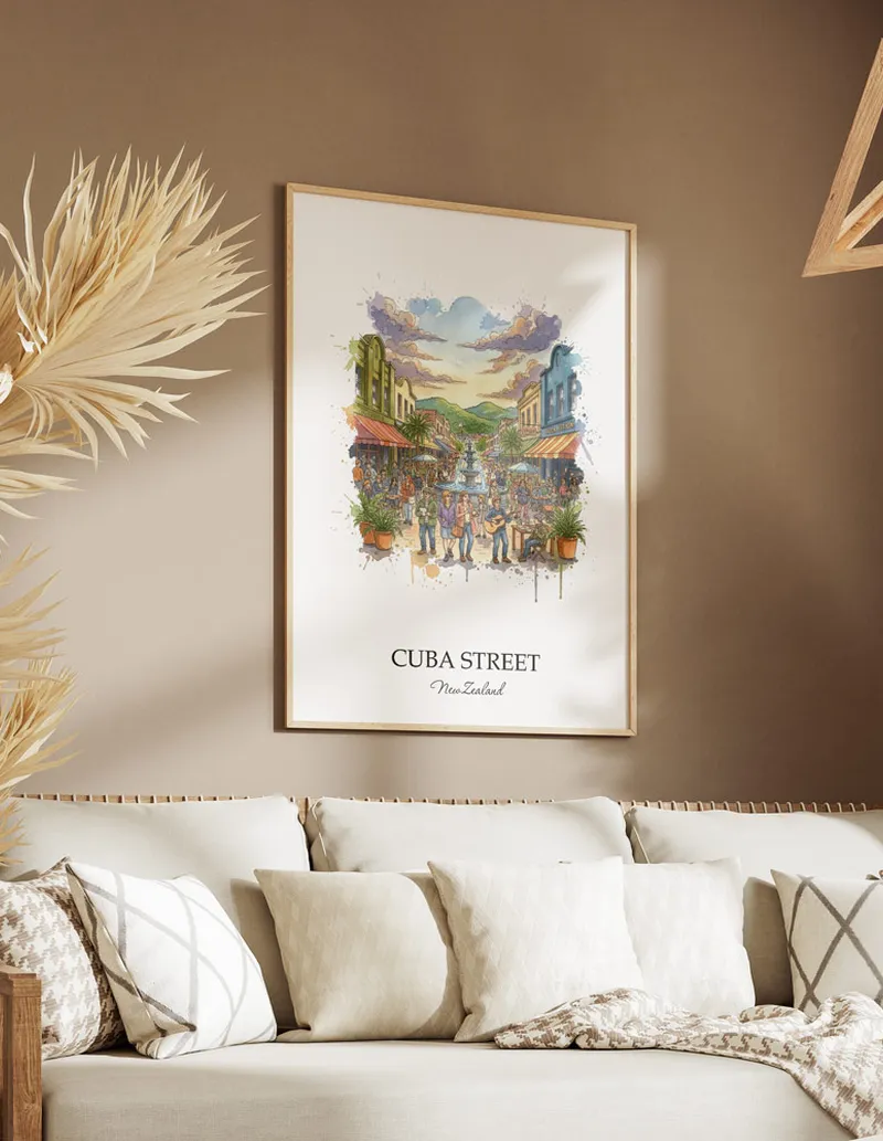 Minimalist poster of Cuba Street in New Zealand in a light frame standing on the floor in a dark moody interior.
