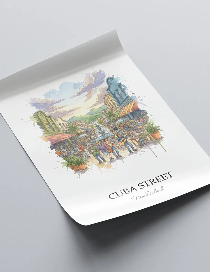 Vintage travel poster of Cuba Street, New Zealand in a light frame displayed above a sofa in a bright boho interior.
