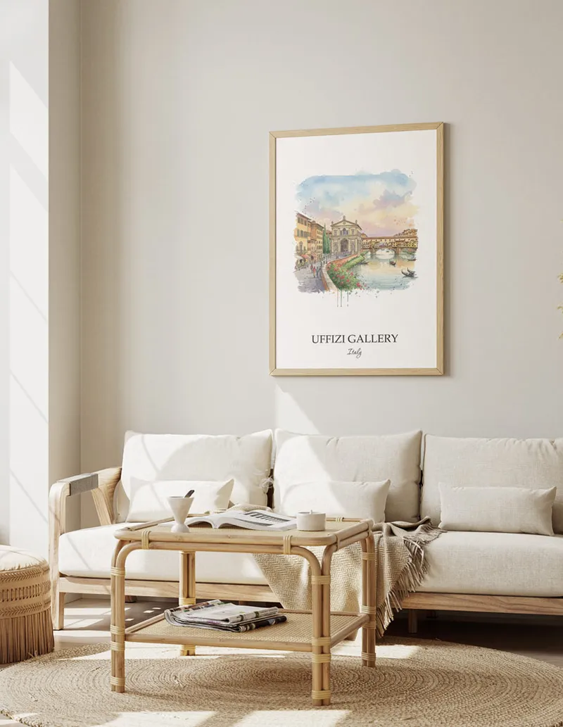 Framed wall art featuring Uffizi Gallery, Italy in a light wood frame hanging above a sofa in a modern living room.