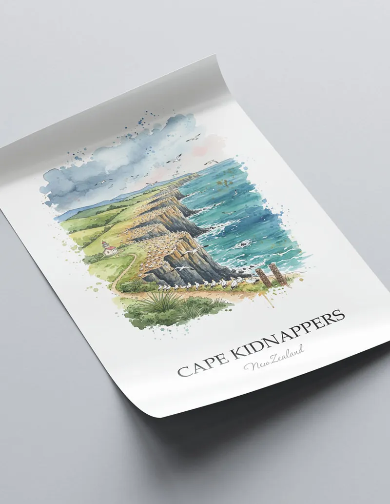 Vintage travel poster of Cape Kidnappers, New Zealand in a light frame displayed above a sofa in a bright boho interior.