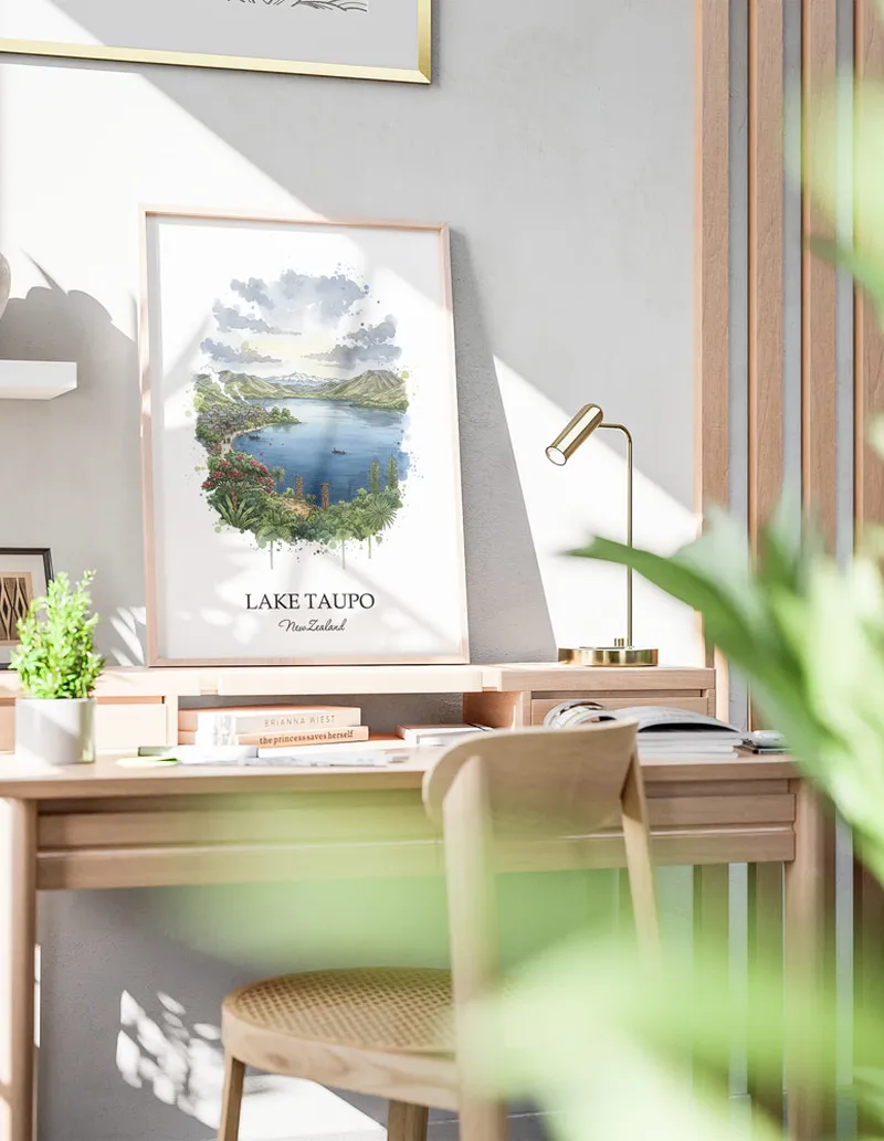 Minimalist poster of Lake Taupo in New Zealand in a light frame standing by a window in a boho style room.
