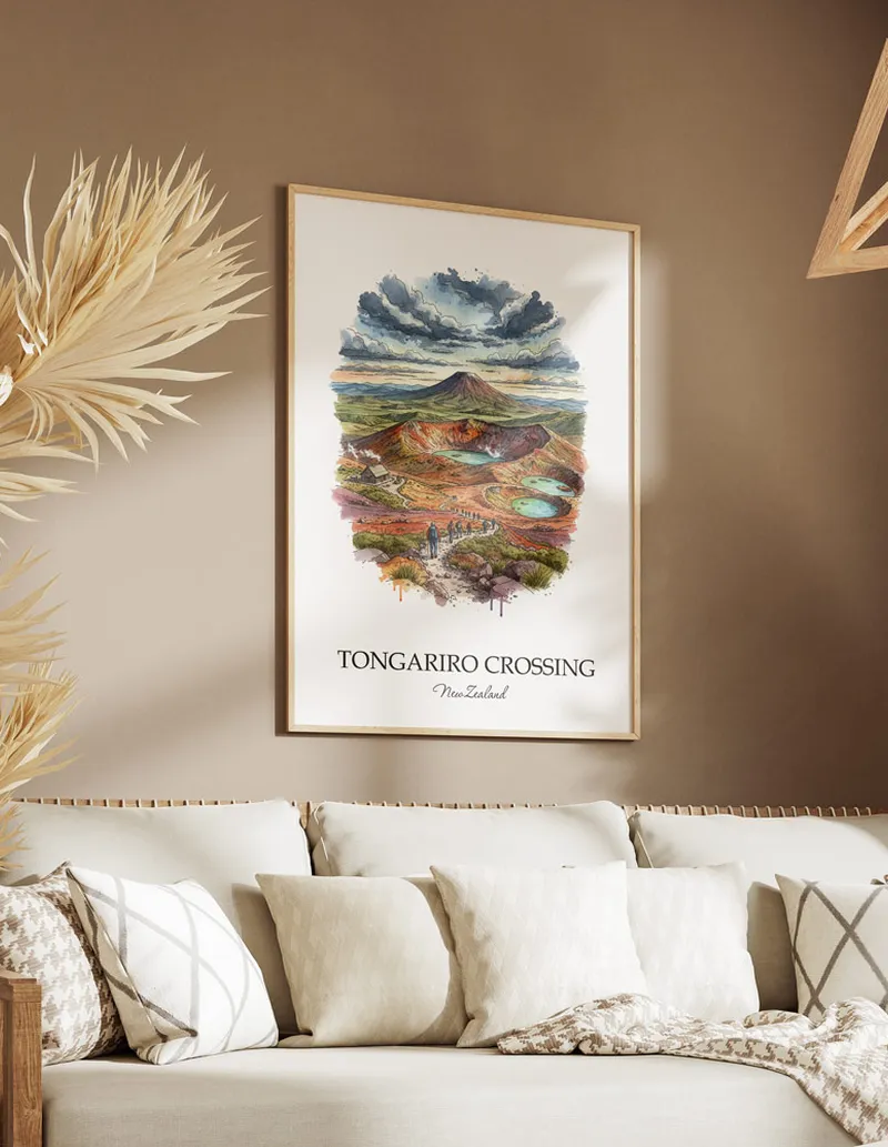 Minimalist poster of Tongariro Crossing in New Zealand in a light frame standing on the floor in a dark moody interior.
