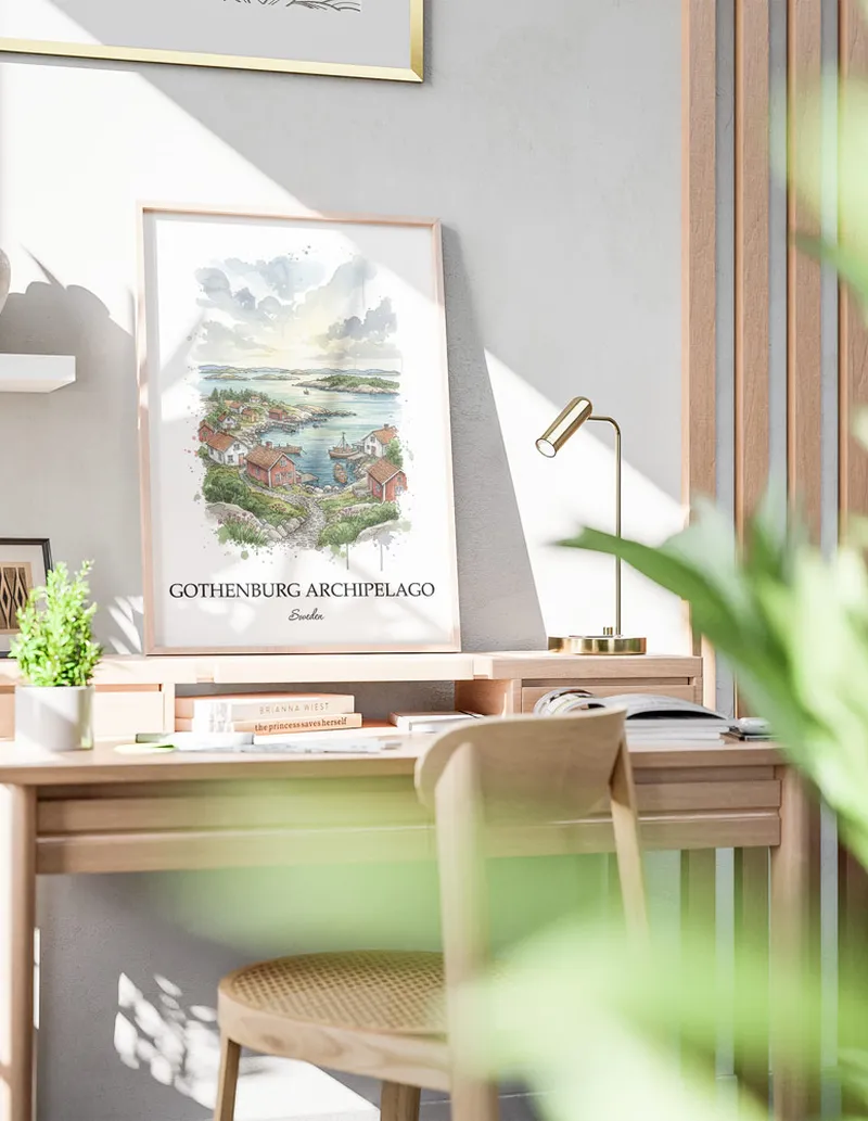 Cozy, well-lit workspace with a minimalist poster of Gothenburg Archipelago, Sweden in a light frame sitting on the desk.