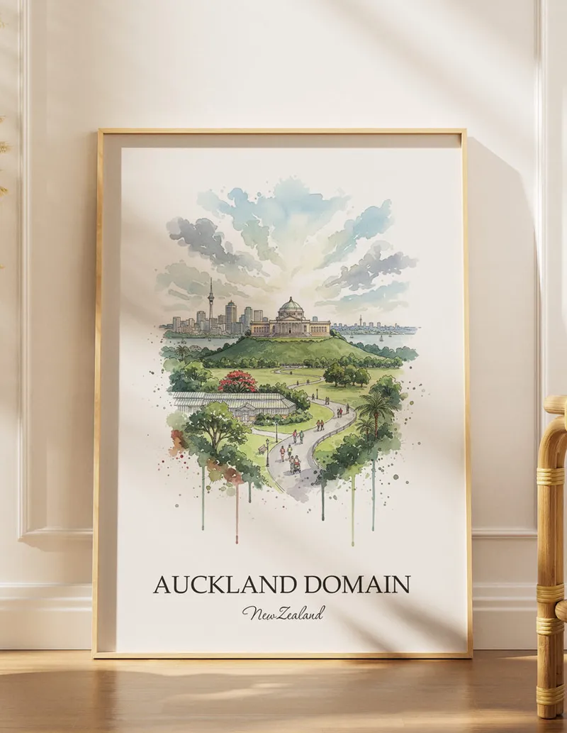 A gorgeous boho-inspired living space with a framed vintage travel poster of Auckland Domain in New Zealand on display.