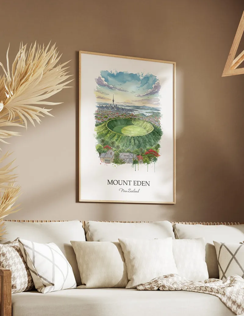 Minimalist poster of Mount Eden in New Zealand in a light frame standing on the floor in a dark moody interior.