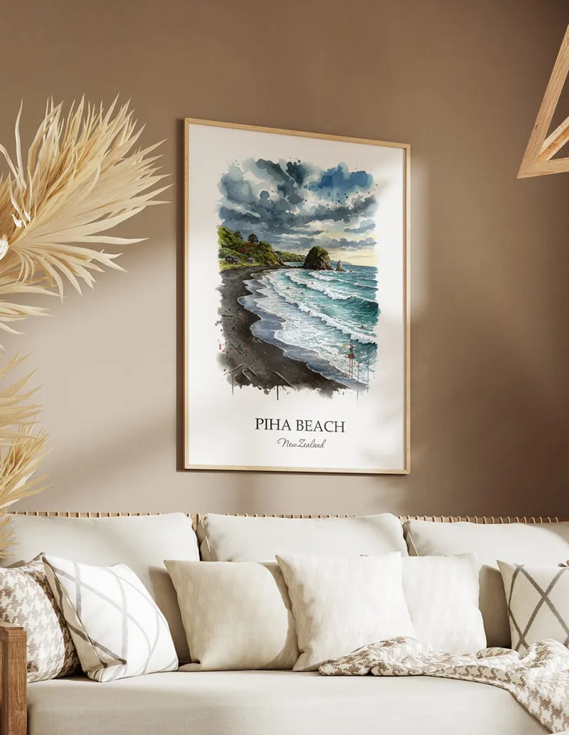Minimalist poster of Piha Beach in New Zealand in a light frame standing on the floor in a dark moody interior.