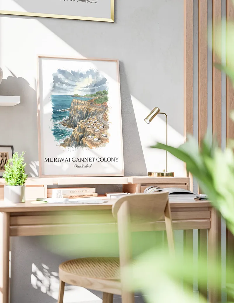 Minimalist poster of Muriwai Gannet Colony in New Zealand in a light frame standing by a window in a boho style room.