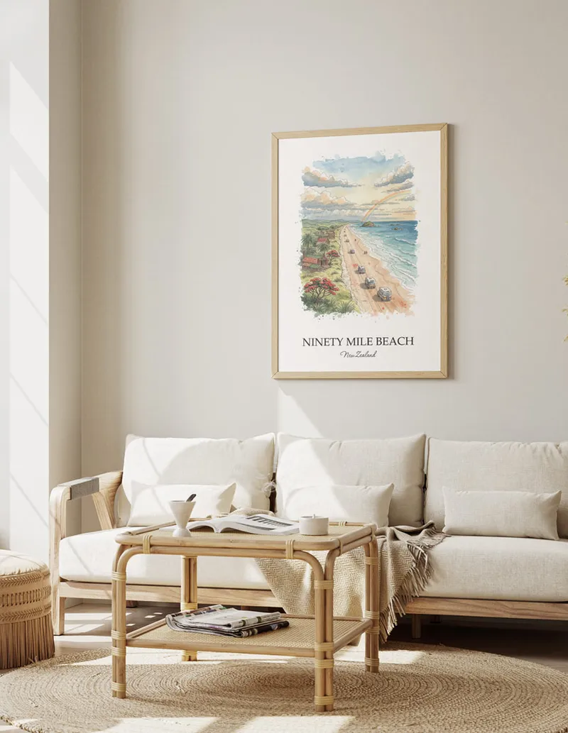Framed wall art featuring Ninety Mile Beach in New Zealand in a light wood frame leaning on the floor.