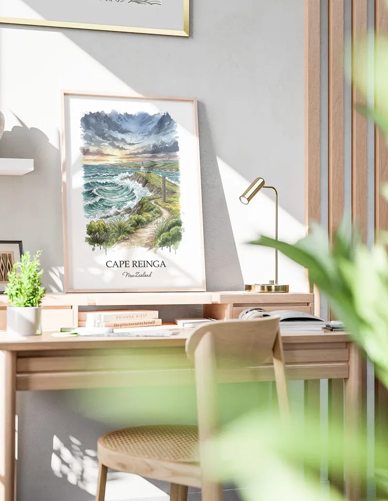 Minimalist poster of Cape Reinga in New Zealand in a light frame standing by a window in a boho style room.