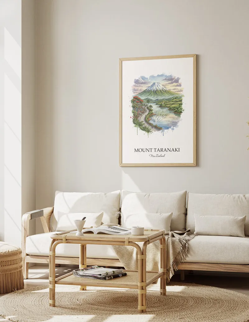 Framed wall art featuring Mount Taranaki in New Zealand in a light wood frame leaning on the floor.