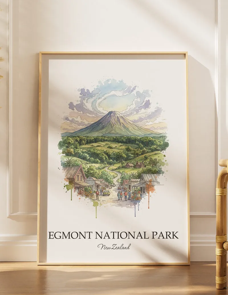 A gorgeous boho-inspired living space with a framed vintage travel poster of Egmont National Park in New Zealand on display.