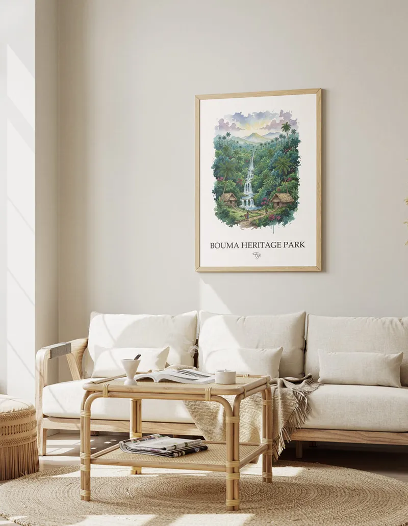 Minimalist poster of Bouma Heritage Park in Fiji in a light frame standing on the floor in a dark moody interior.