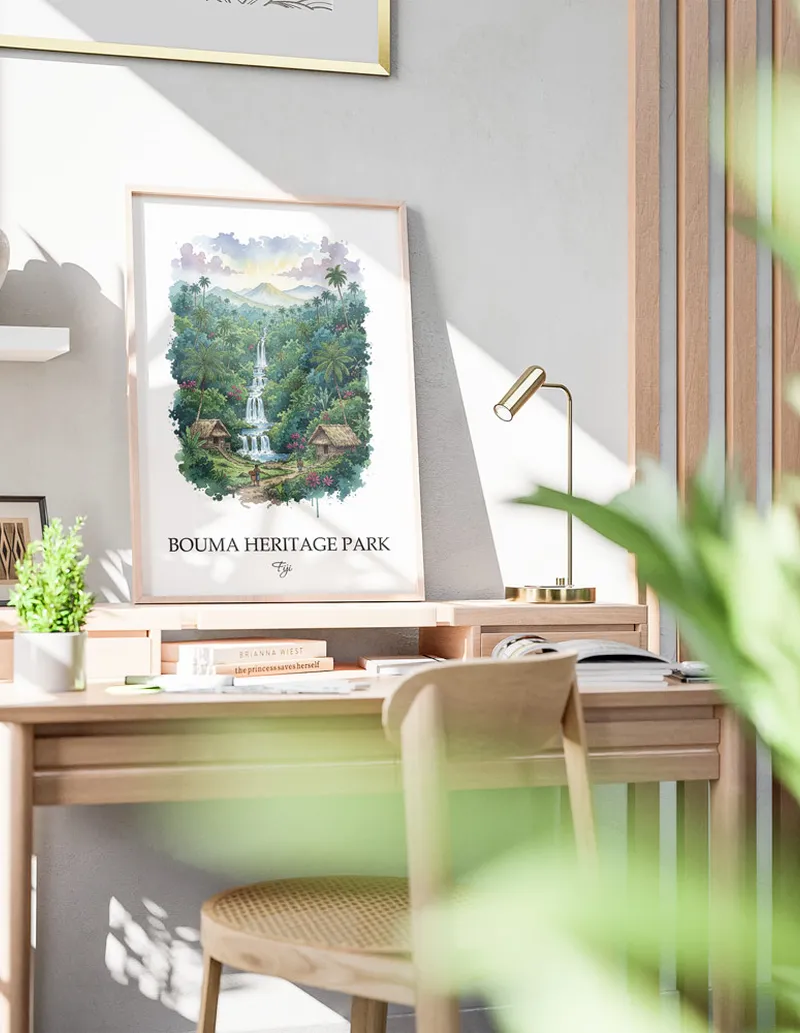 Framed wall art featuring Bouma Heritage Park, Fiji in a light wood frame hanging above a sofa in a modern living room.
