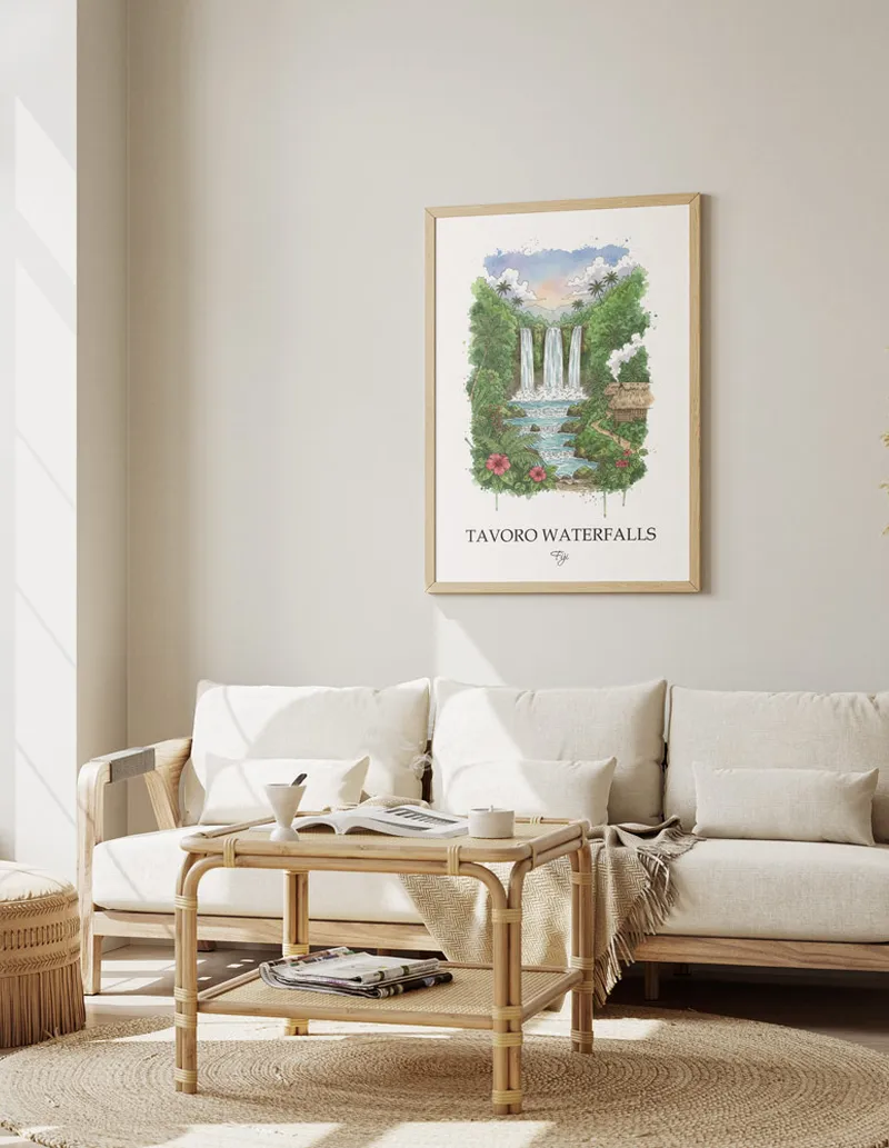 Minimalist poster of Tavoro Waterfalls in Fiji in a light frame standing on the floor in a dark moody interior.