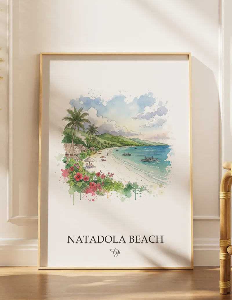 Cozy, well-lit workspace with a minimalist poster of Natadola Beach, Fiji in a light frame sitting on the desk.