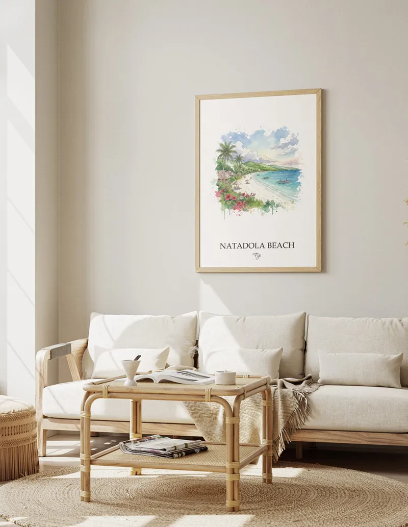 Minimalist poster of Natadola Beach in Fiji in a light frame standing on the floor in a dark moody interior.