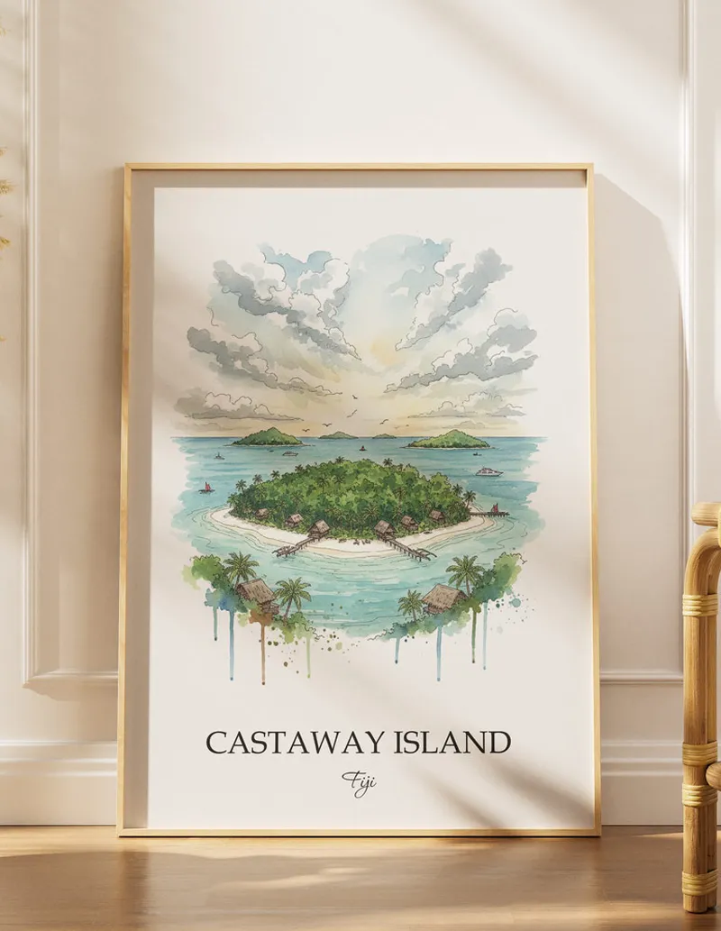 Cozy, well-lit workspace with a minimalist poster of Castaway Island, Fiji in a light frame sitting on the desk.