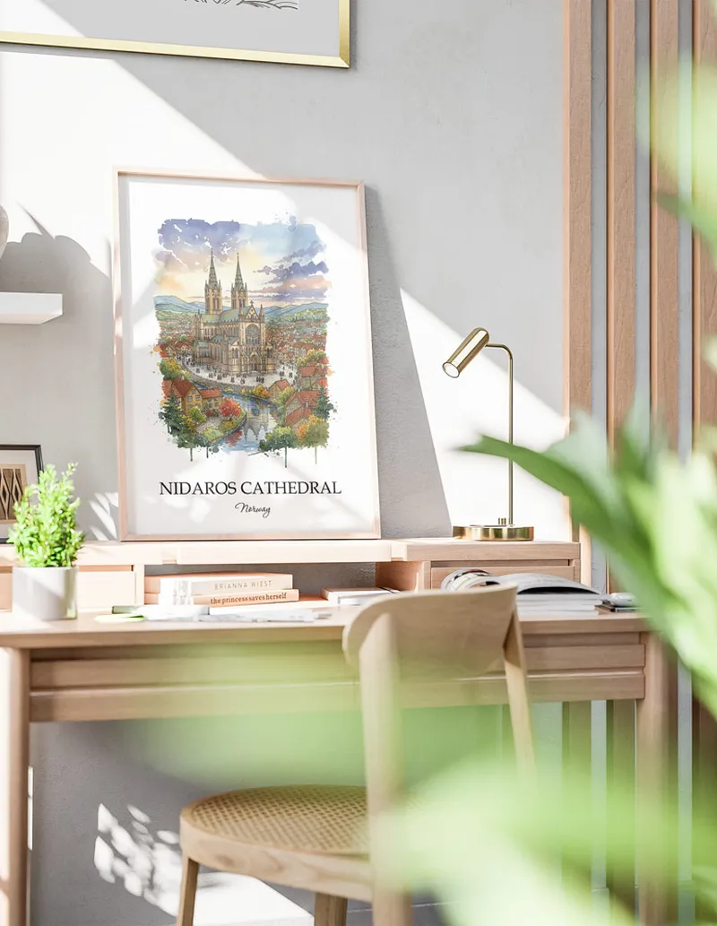 Cozy, well-lit workspace with a minimalist poster of Nidaros Cathedral, Norway in a light frame sitting on the desk.