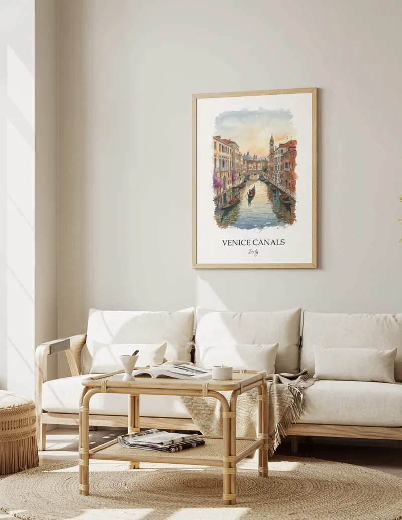 Framed wall art featuring Venice Canals, Italy in a light wood frame hanging above a sofa in a modern living room.