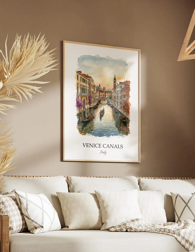 Vintage travel poster of Venice Canals, Italy in a light frame displayed above a sofa in a bright boho interior.
