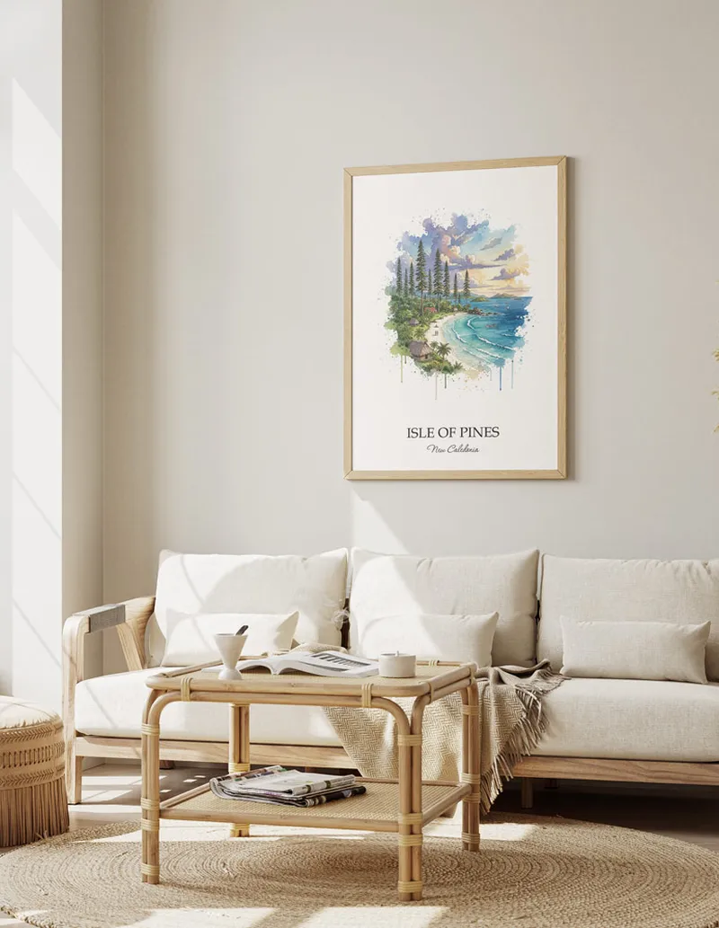 Minimalist poster of Isle of Pines in New Caledonia in a light frame standing on the floor in a dark moody interior.