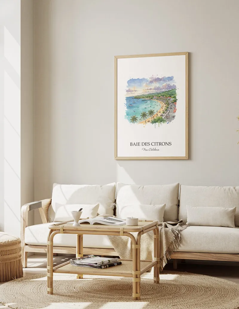 Minimalist poster of Baie des Citrons in New Caledonia in a light frame standing on the floor in a dark moody interior.