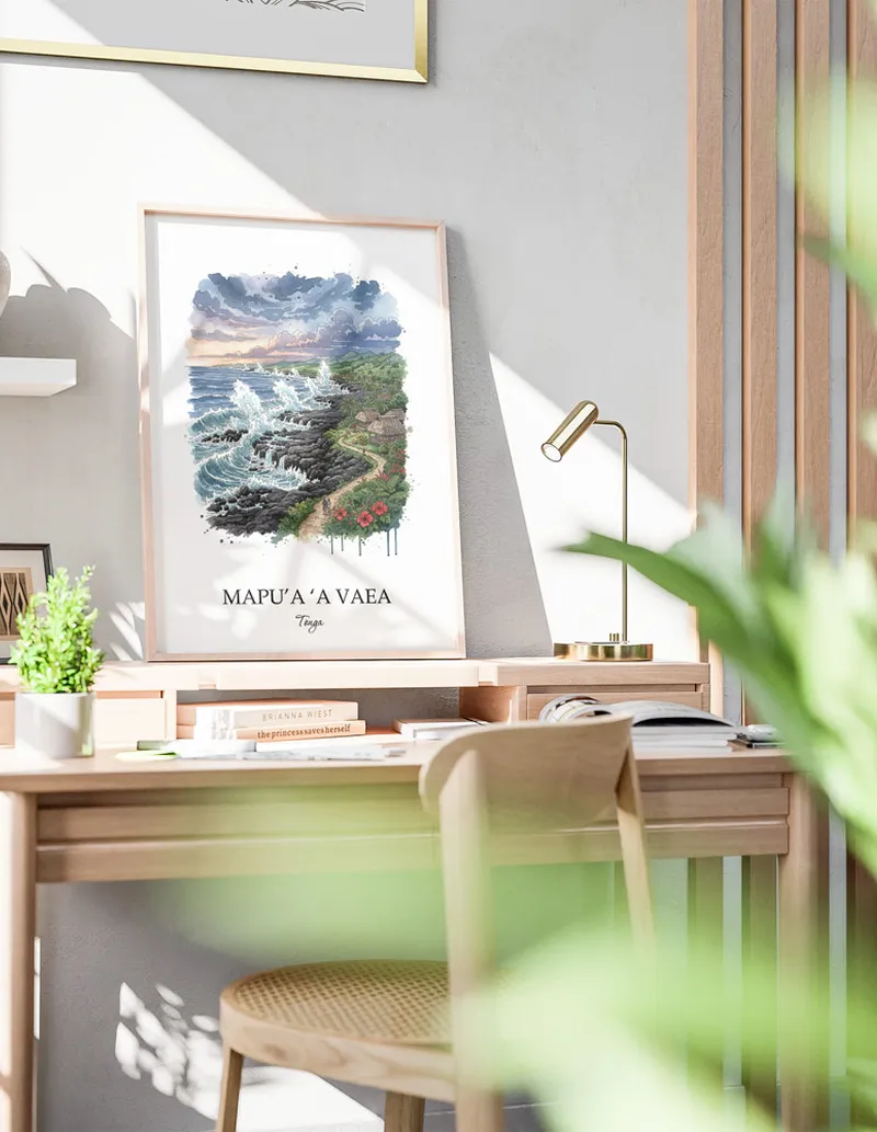 Framed wall art featuring Mapu'a 'a Vaea, Tonga in a light wood frame hanging above a sofa in a modern living room.
