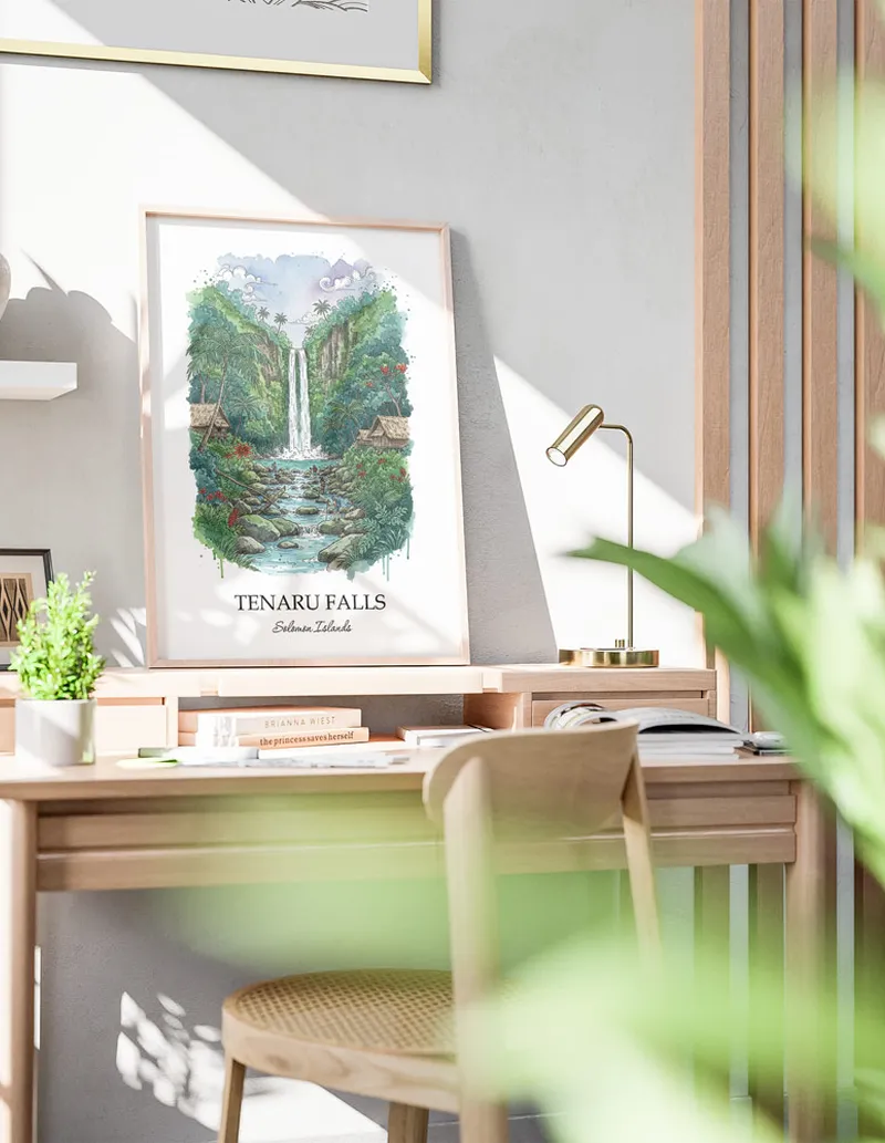 Framed wall art featuring Tenaru Falls, Solomon Islands in a light wood frame hanging above a sofa in a modern living room.