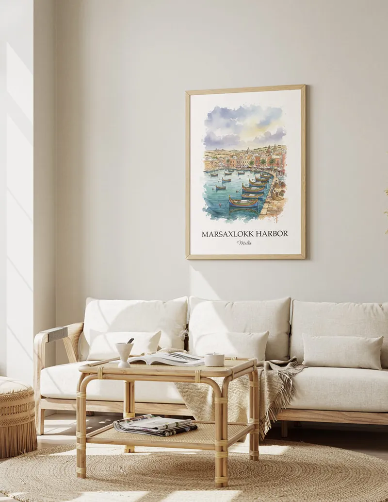 Framed wall art featuring Marsaxlokk Harbor, Malta in a light wood frame hanging above a sofa in a modern living room.