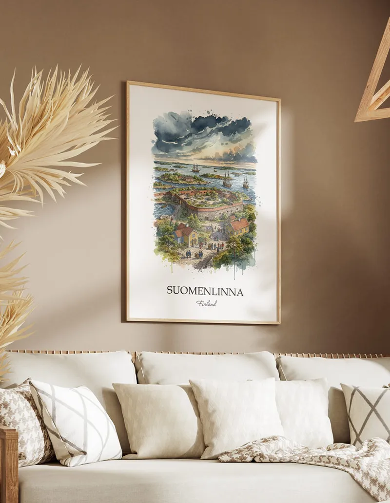 Vintage travel poster of Suomenlinna, Finland in a light frame displayed above a sofa in a bright boho interior.