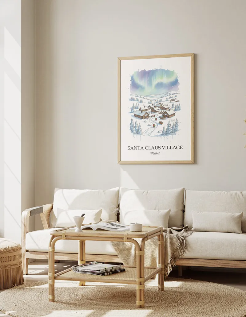 Framed wall art featuring Santa Claus Village, Finland in a light wood frame hanging above a sofa in a modern living room.