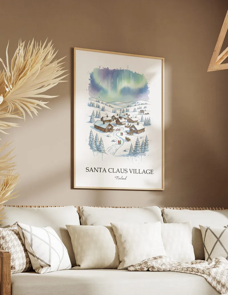 Vintage travel poster of Santa Claus Village, Finland in a light frame displayed above a sofa in a bright boho interior.