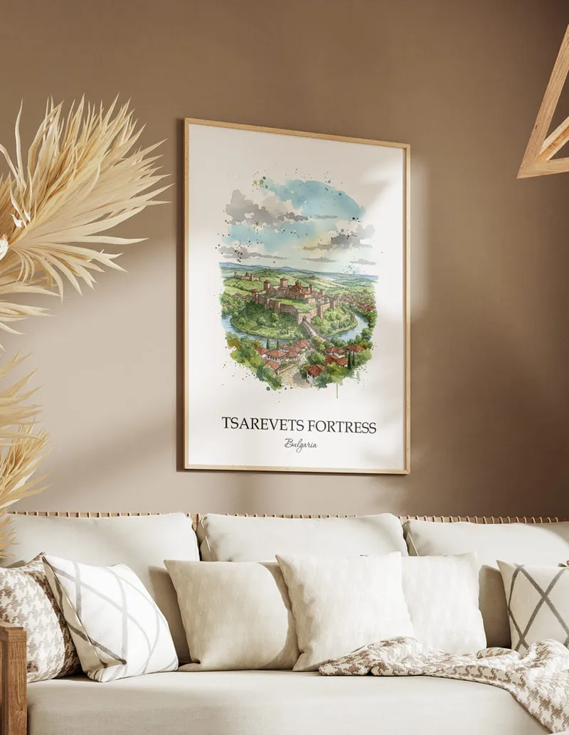 A gorgeous boho-inspired living space with a framed vintage travel poster of Tsarevets Fortress in Bulgaria on display.