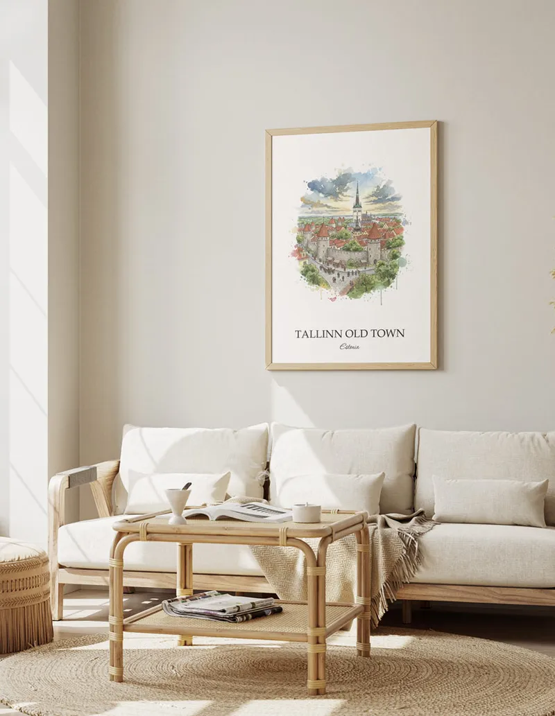 Vintage travel poster of Tallinn Old Town, Estonia in a light frame displayed above a sofa in a bright boho interior.
