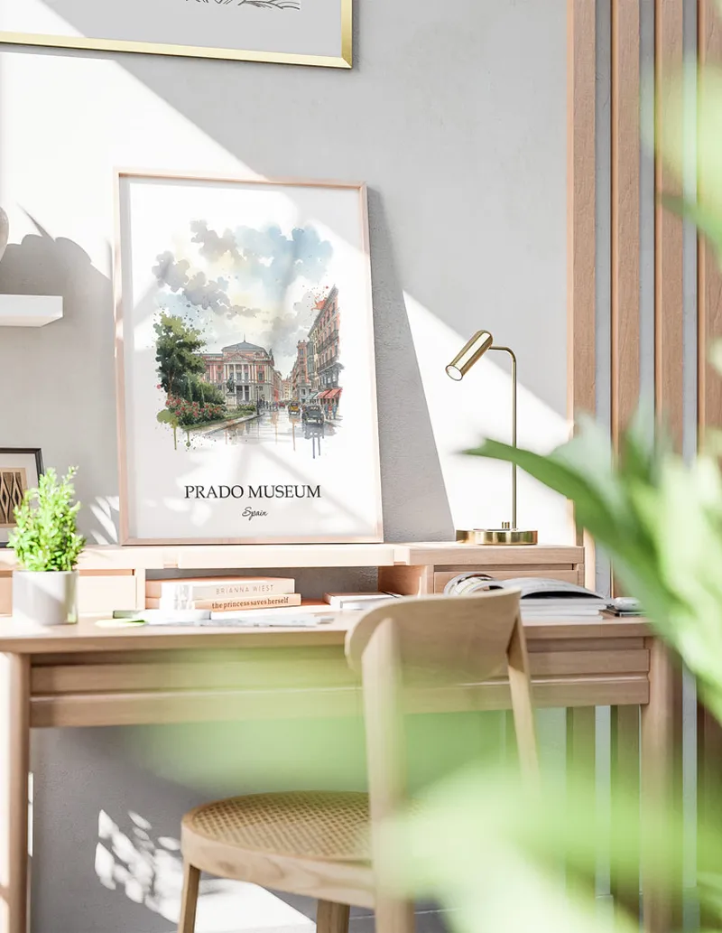 Cozy, well-lit workspace with a minimalist poster of Prado Museum, Spain in a light frame sitting on the desk.