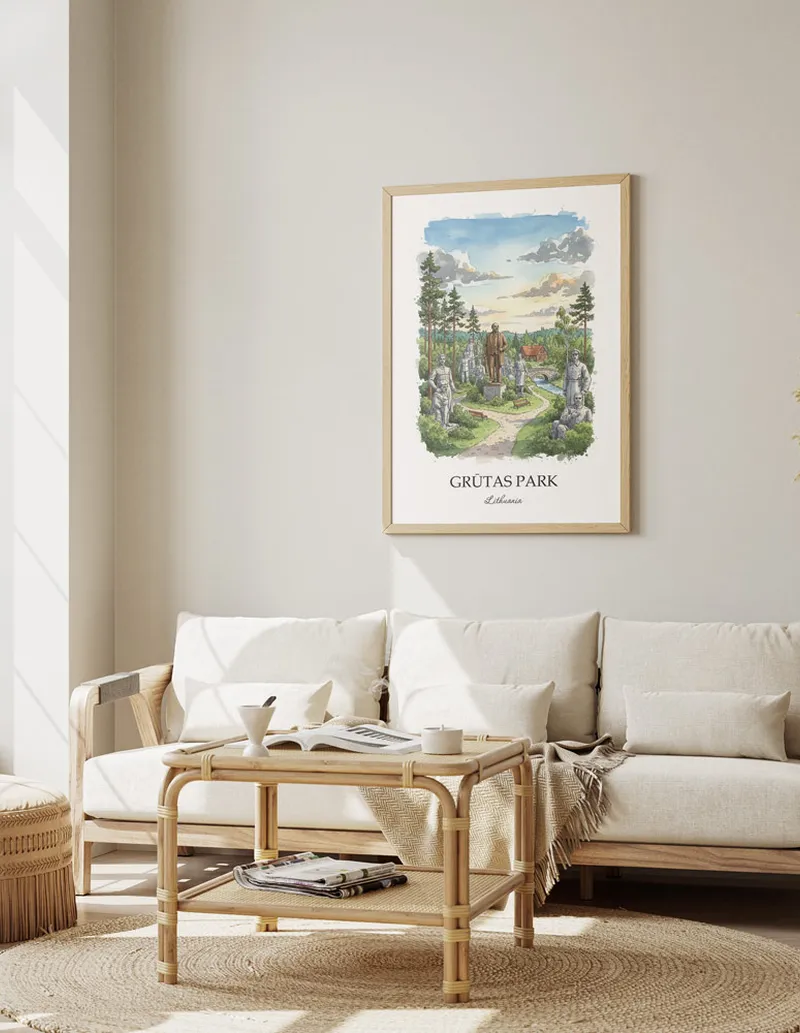Vintage travel poster of Gr_tas Park, Lithuania in a light frame displayed above a sofa in a bright boho interior.