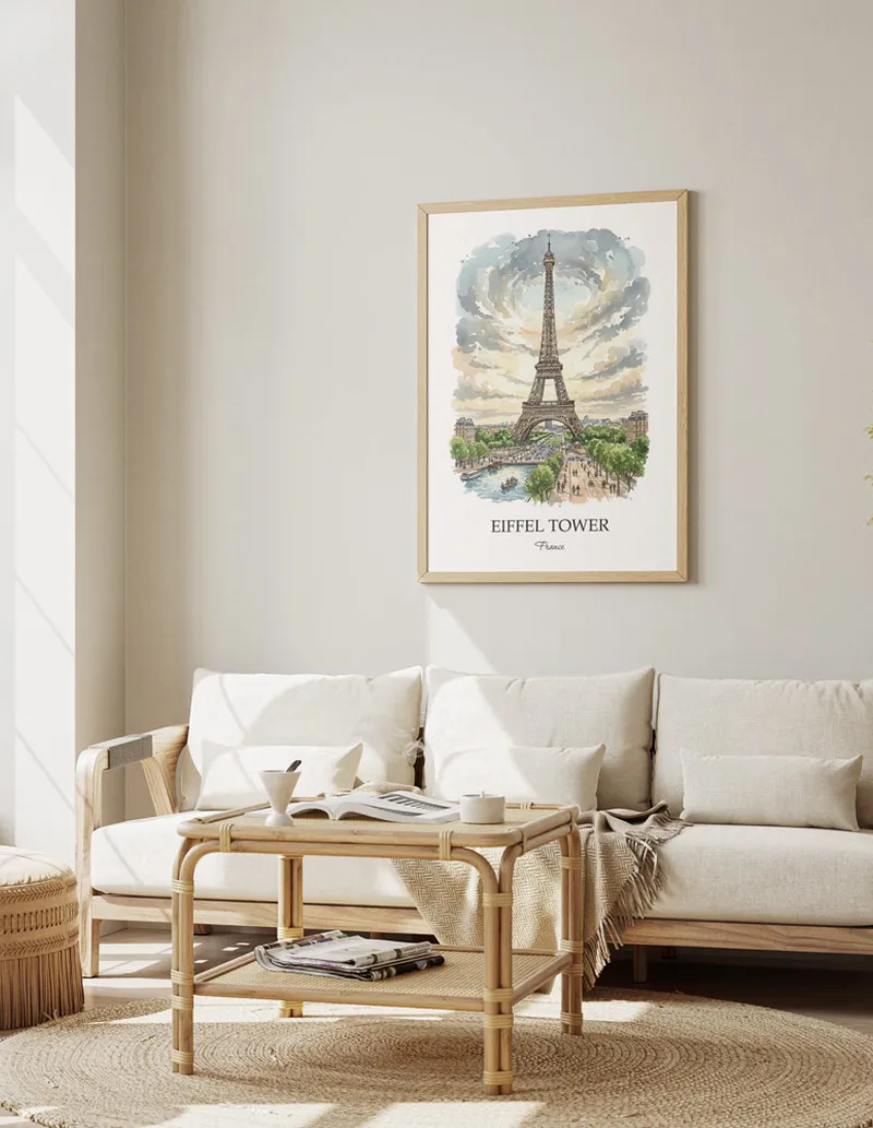 Framed wall art featuring Eiffel Tower, France in a light wood frame hanging above a sofa in a modern living room.