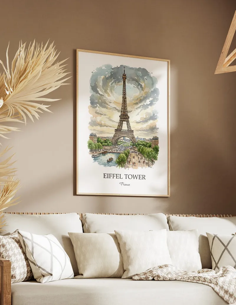 Vintage travel poster of Eiffel Tower, France in a light frame displayed above a sofa in a bright boho interior.
