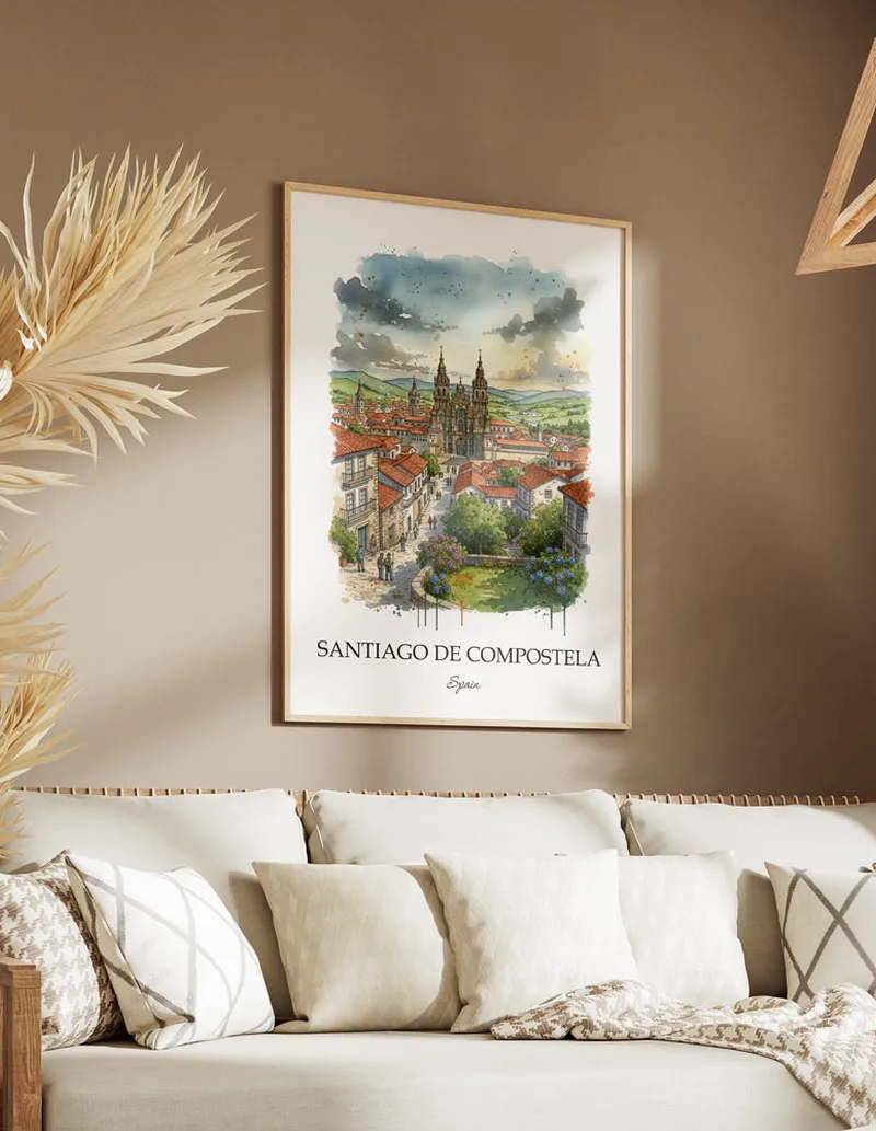 Vintage travel poster of Santiago de Compostela, Spain in a light frame displayed above a sofa in a bright boho interior.