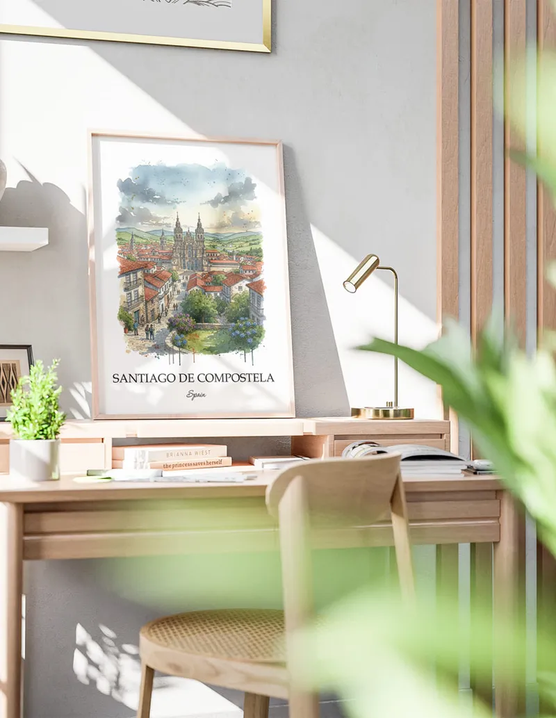 Cozy, well-lit workspace with a minimalist poster of Santiago de Compostela, Spain in a light frame sitting on the desk.