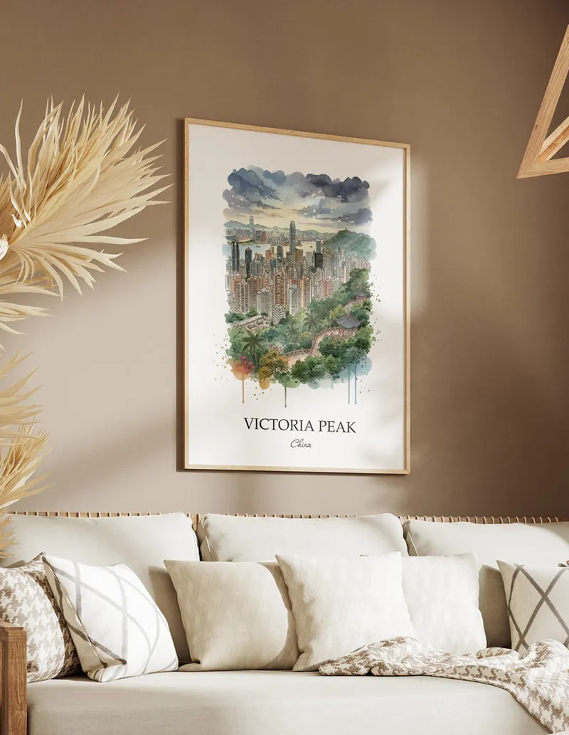 Framed wall art featuring Victoria Peak, China in a light wood frame hanging above a sofa in a modern living room.