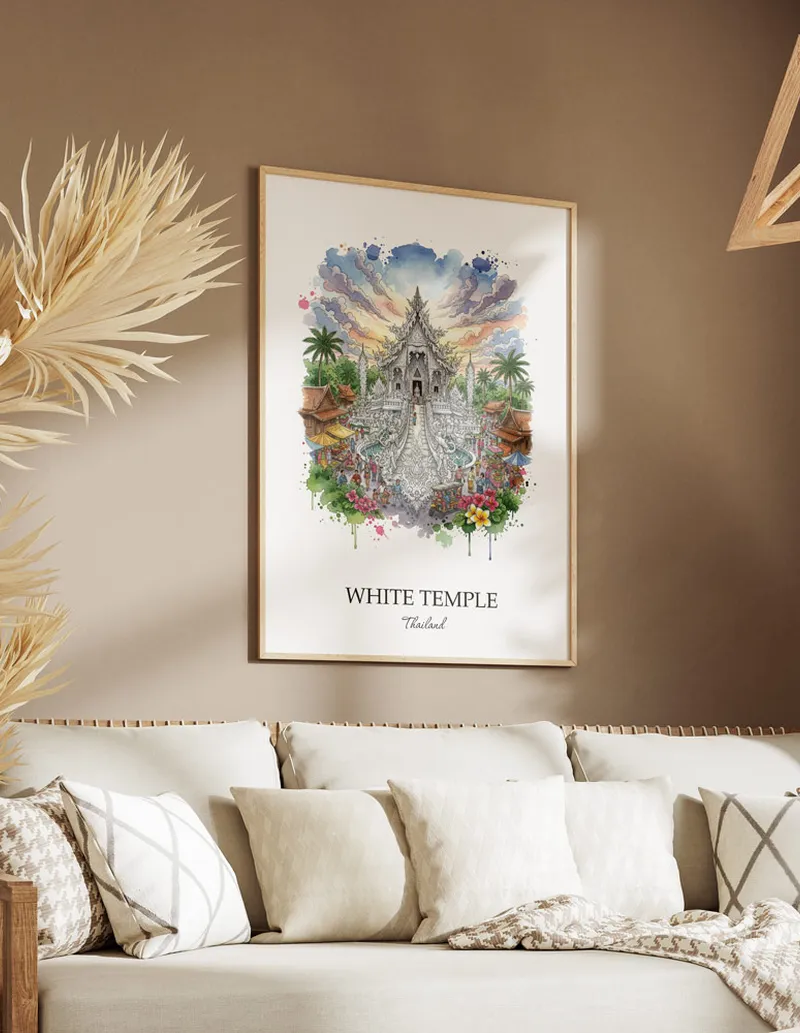 Framed wall art featuring White Temple, Thailand in a light wood frame hanging above a sofa in a modern living room.