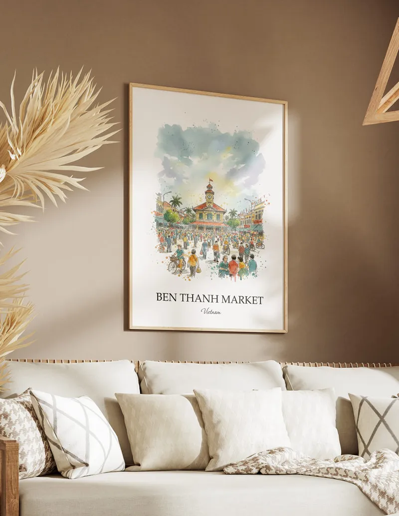 Framed wall art featuring Ben Thanh Market, Vietnam in a light wood frame hanging above a sofa in a modern living room.