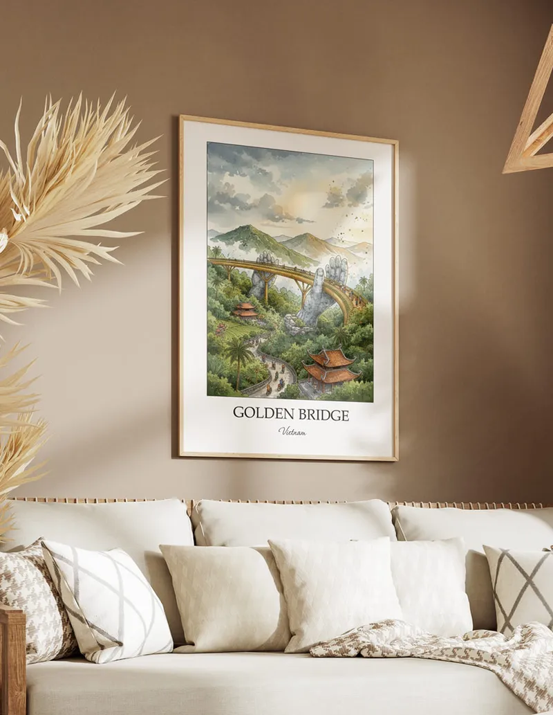 Framed wall art featuring Golden Bridge, Vietnam in a light wood frame hanging above a sofa in a modern living room.
