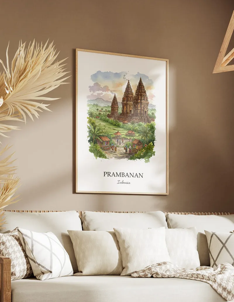 Framed wall art featuring Prambanan, Indonesia in a light wood frame hanging above a sofa in a modern living room.