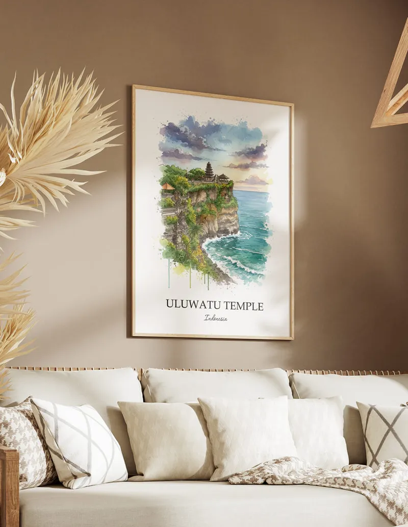 Framed wall art featuring Uluwatu Temple, Indonesia in a light wood frame hanging above a sofa in a modern living room.